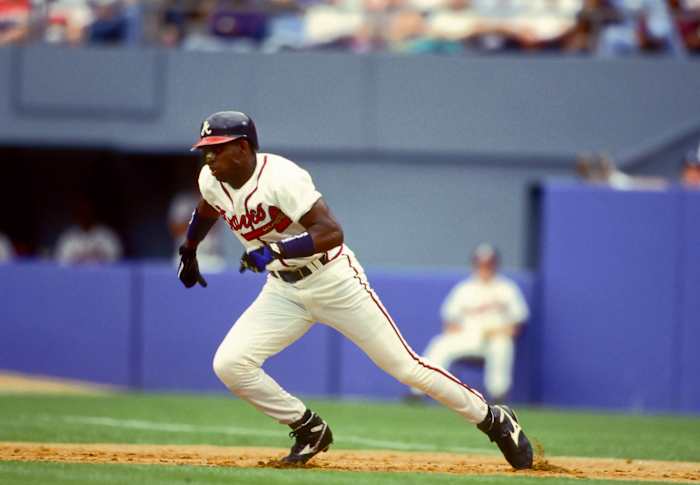 Atlanta Braves outfielder Deion Sanders steals second base.